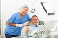 Satisfied patient visiting dentist giving thumbs up Royalty Free Stock Photo