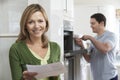 Satisfied Female Customer With Oven Repair Bill Royalty Free Stock Photo