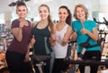 Satisfied females of different age training on exercise bikes Royalty Free Stock Photo