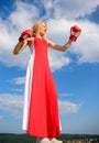 Satisfied free girl boxing gloves. Femininity and strength balance. Woman red dress and boxing gloves enjoy victory. She