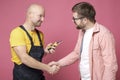 Satisfied, grateful client makes a handshake gesture with a worker who did a good job. Royalty Free Stock Photo
