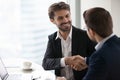 Satisfied happy businessman in suit handshake business partner making deal Royalty Free Stock Photo