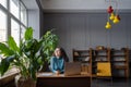 Satisfied happy female employee relaxing at workplace, happy female enjoying break during workday Royalty Free Stock Photo