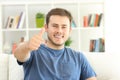 Satisfied home owner looking at you with thumbs up