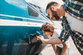 Satisfied man and boy watching petrol tank Royalty Free Stock Photo