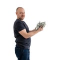 Satisfied man in jeans and a T-shirt with money, dollars in hand isolated on a white background. Profit, wealth, winning the Royalty Free Stock Photo