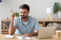 Satisfied man with raised hand thinking about good creative idea Royalty Free Stock Photo