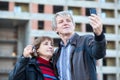 Satisfied mature husband and wife making picture with house key in hand Royalty Free Stock Photo