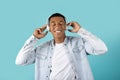 Satisfied millennial black guy in wireless headphones with closed eyes listen to music, enjoy audio app