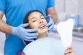 Satisfied patient at the dentist. who demonstrates his perfect smile after treatment