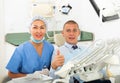 Satisfied patient visiting dentist giving thumbs up Royalty Free Stock Photo