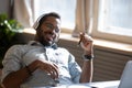 Satisfied relaxed African American man wearing headphones enjoying music Royalty Free Stock Photo