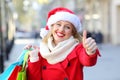 Satisfied shopper with thumbs up on christmas