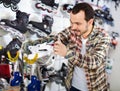 Male master fixing roller-skates in sports store