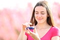 Satisfied woman applying moisturizer in nature