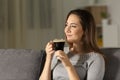 Satisfied woman enjoying coffee in the night