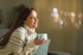 Satisfied woman holding coffee mug in the night in winter Royalty Free Stock Photo