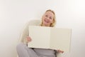 satisfied woman opened album empty space space for advertising photos Memories white background white pages blond hair