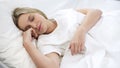 Satisfied woman sleeping in bed, relaxation time, resting after hard busy week