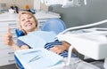 Satisfied woman visiting dentist giving thumbs up Royalty Free Stock Photo