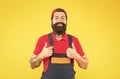 satisfied with the work done. brutal bearded man in uniform. guy worker in coveralls and cap. male worker builder or Royalty Free Stock Photo