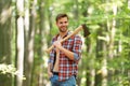 Satisfied for the work done. cutter going to cut tree. lumberjack holding ax in hands. wanderlust, hiking and travel