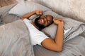 Satisfied young African American man stretching after wake up Royalty Free Stock Photo