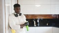 Satisfied young black man admiring cleanlines of the kitchen after work