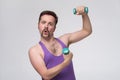 Satisfied young strength retro man lifting dumbbell Royalty Free Stock Photo