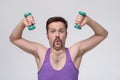 Satisfied young strength retro man lifting dumbbell Royalty Free Stock Photo