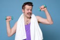 Satisfied young strength retro man lifting dumbbell Royalty Free Stock Photo