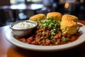 Satisfying chili bowl with cornbread and sour cream under dusky ultra wide angle