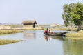 Satkhira, Bangladesh - 29 January 2017 - Mother with her young Child, on a floating boat, on the pond, fishing, countryside