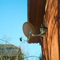 Sattelite dish on a wooden house wall Royalty Free Stock Photo