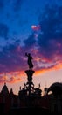 Satue and kiosk in backlight, colorful sunset scene with sky and clouds