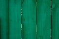 Saturated dark green wooden planking background with cracks Royalty Free Stock Photo