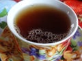 Invigorating black tea with froth in a beautiful cup.