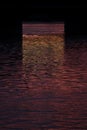 Saturated ripple surface of water on sunset in dark colorful color of purple, orange, golden color with black frame, abstract. Royalty Free Stock Photo