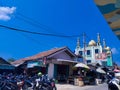 Saturday, August 2023 neatly parked rows of motorbikes, lots of food vendors on the roadside at the market in Bandar Lampung