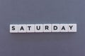 Saturday word made of square letter word on grey background