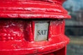 Saturday word shown as SAT on a British red letter box.