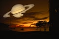 Saturn back on night cloud sunset sky silhouette boat on sea