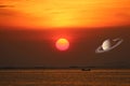 Saturn on sunset sky back over sea and fishing boat Royalty Free Stock Photo