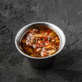 Sauce with hot pepper in bowl on black stone background Royalty Free Stock Photo