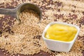 Sauce and seeds of yellow mustard - Sinapis alba. Wooden background Royalty Free Stock Photo