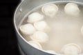 Saucepan with dumplings in hot water coming to a boil a second before filling the stomach semi-finished