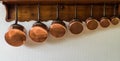 Saucepans hanging in the kitchen Royalty Free Stock Photo