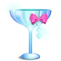 A saucer glass or ramekin of champagne decorated with a pendant or earring with artificial diamonds and pink ribbon bow