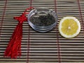 Saucer with tea and a row a lemon, on a rug Royalty Free Stock Photo