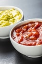 Sauces in bowl. Guacamole and tomato dip